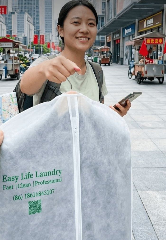 Customer handing over clothes in an Easy Life Laundry garment bag
