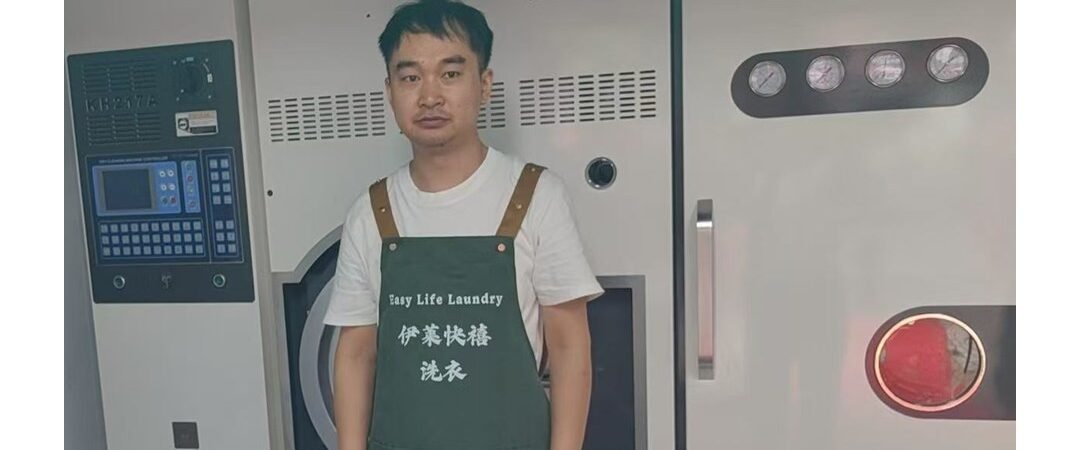Easy Life Laundry team member in front of a dry cleaning machine, Foshan